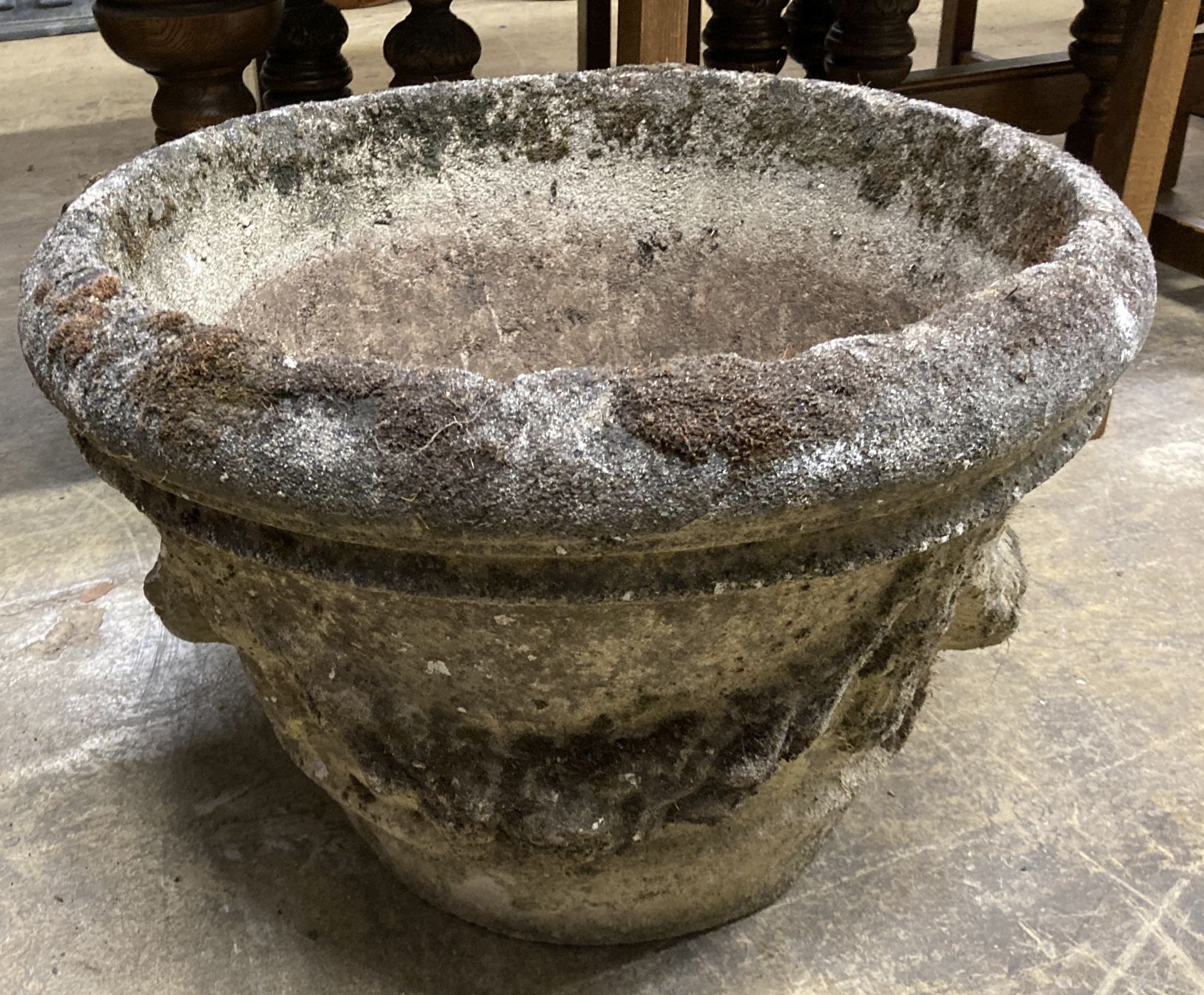 A reconstituted stone garden urn, 49cm diameter, height 34cm